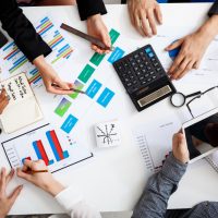 businessmen-hands-on-white-table-with-documents-and-drafts